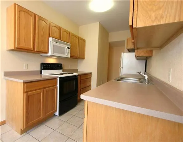 Galley kitchen with full appliances